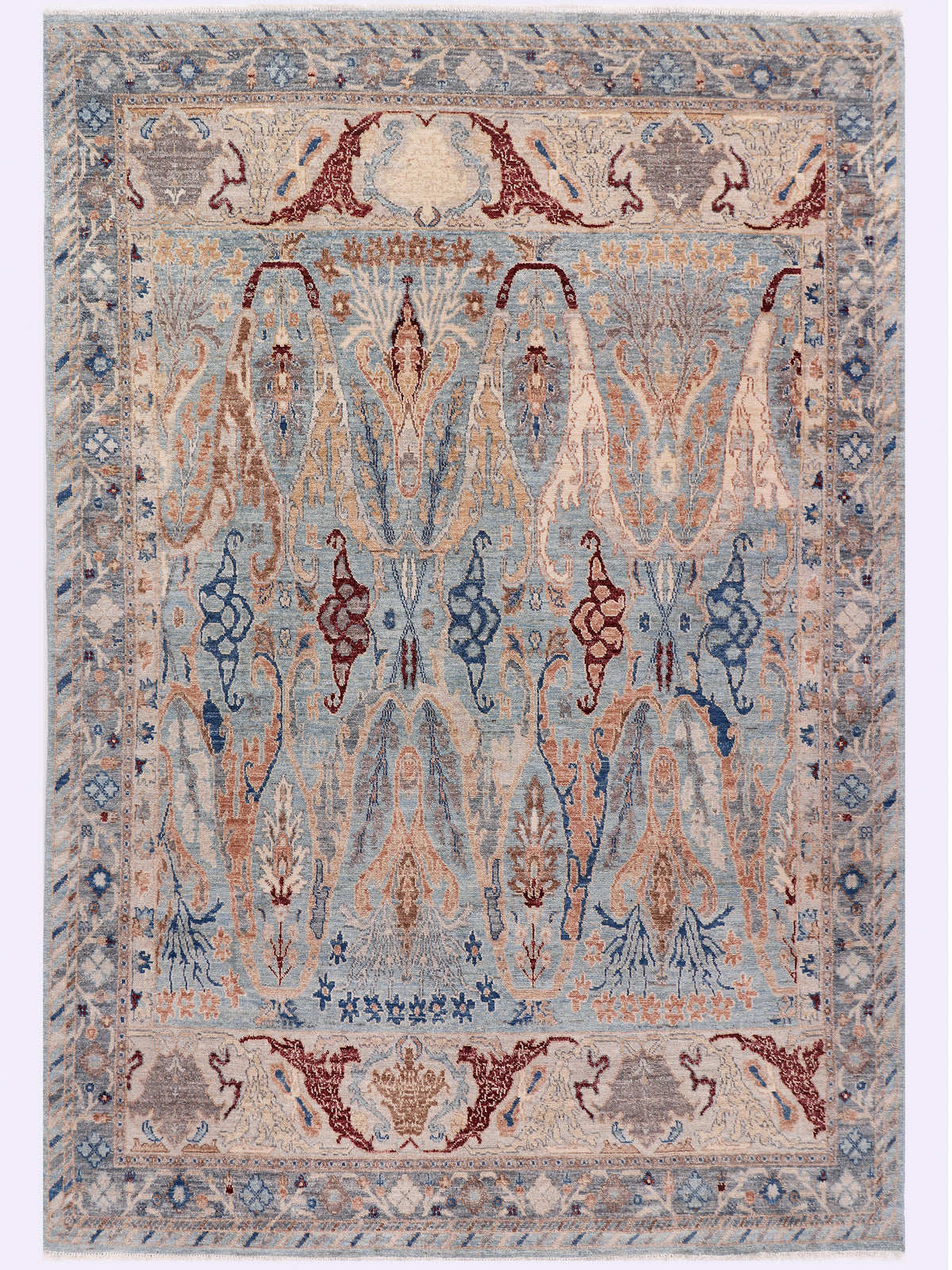 Khyber Oushak rug, symmetric light blue design with dark blue and terracotta motifs