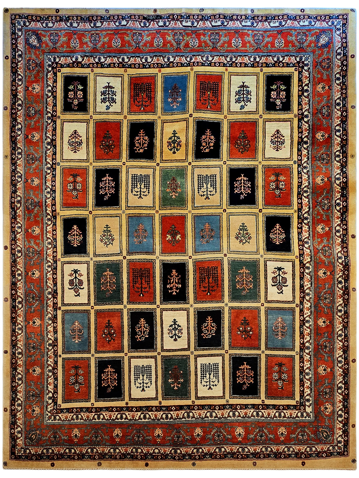 Square rug with repeating red, blue, cream panels and ornate border with corner accents