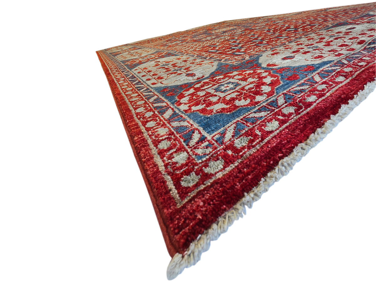 Mamluk rug corner with red field, navy accents, cream scroll medallions, and fringe