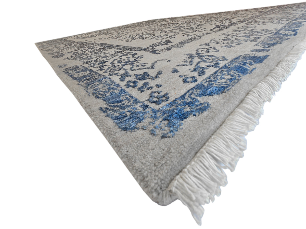 Modern rug 310x244 cm angled view showing blue motif and long white fringes