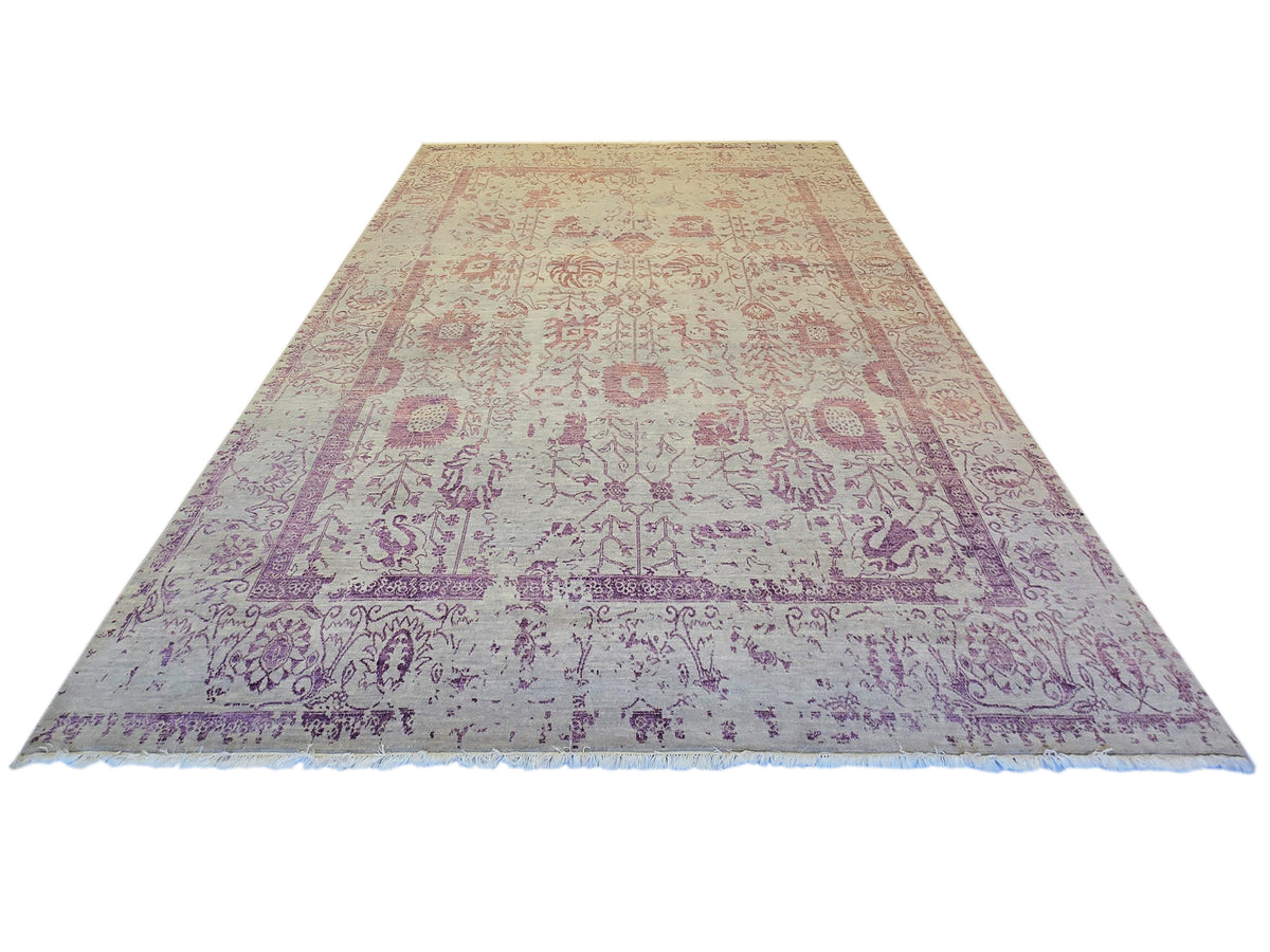 Modern beige area rug with purple ornate center panel and border, flat finish