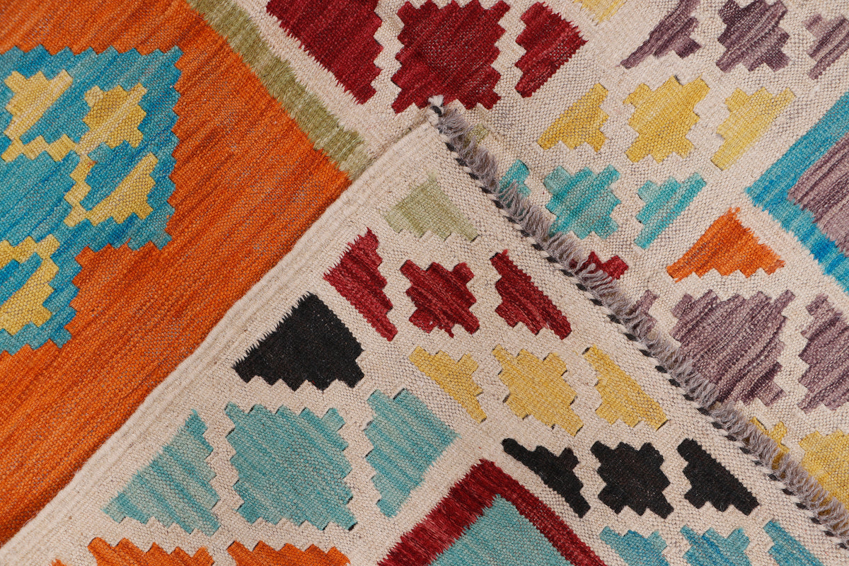 Kilim rug corner with multicolor geometric blocks and fringed border