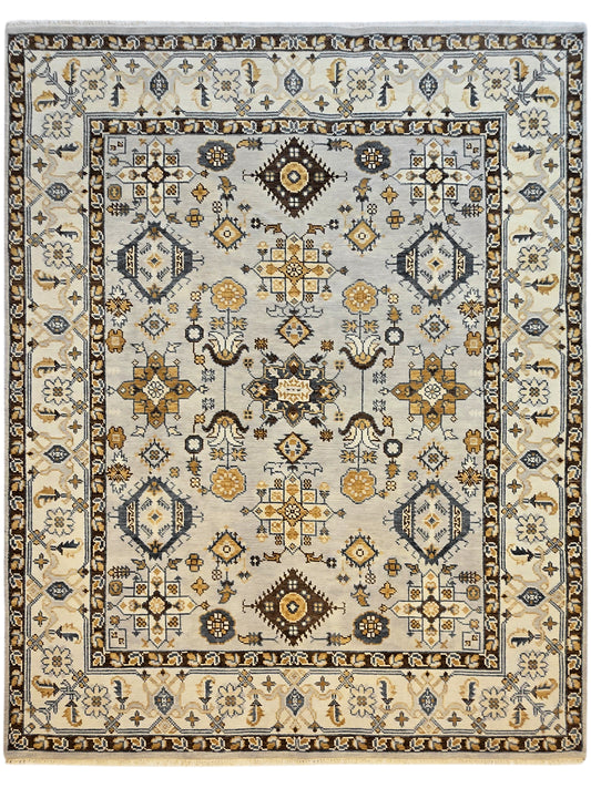 Square Oushak rug with ivory field, navy and gold medallion, symmetrical geometric border design.