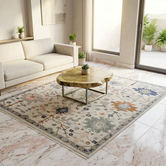 Oushak rug styled in a living room, light beige center with blue border and multicolor motifs
