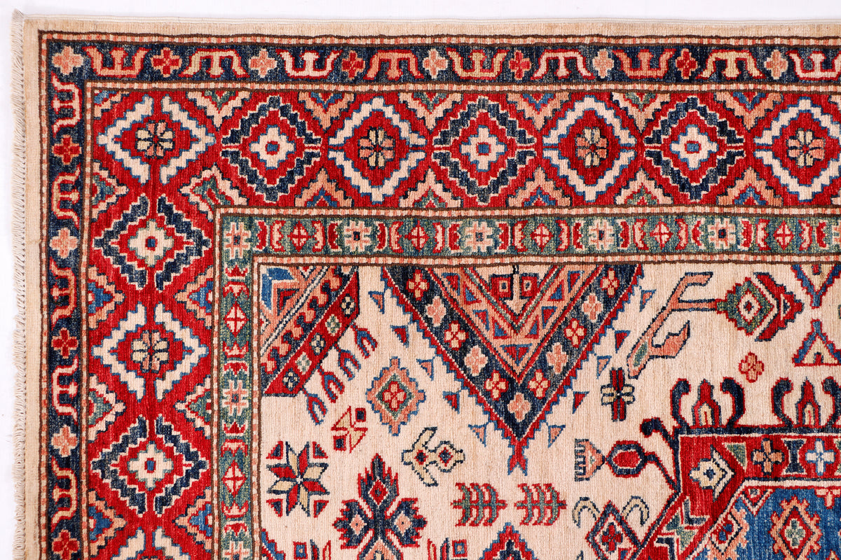 Blue Kazak rug close-up showing red diamond pattern and cream background