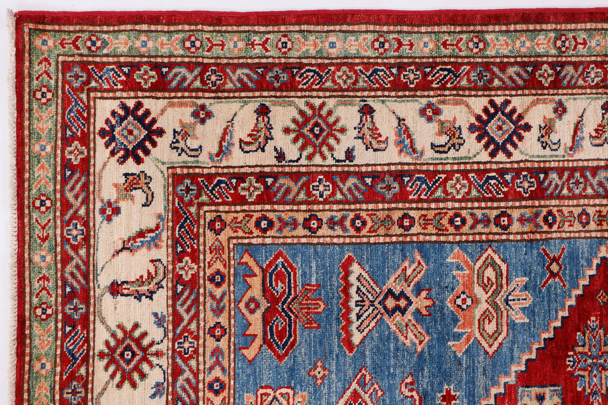Red and blue Kazak rug with geometric border and diamond medallion pattern