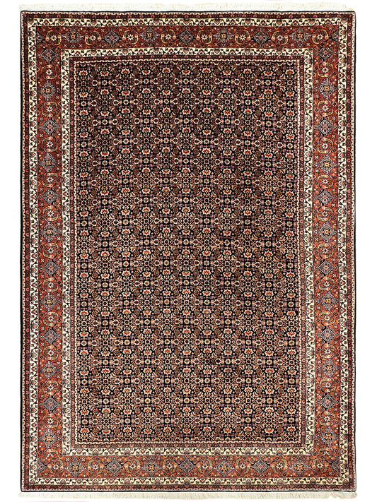 Rectangular rug with central medallion and border in rust, black, and cream