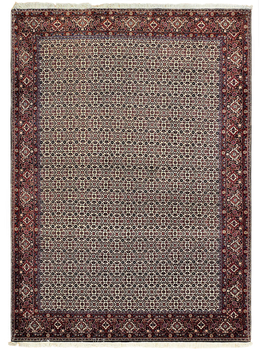 Bidjar rug with central ivory field, dark red border, and repeating medallion motifs