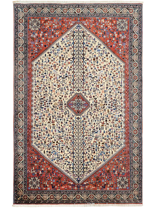 Rectangular rug with cream diamond medallion on red field, ornate navy and ivory border