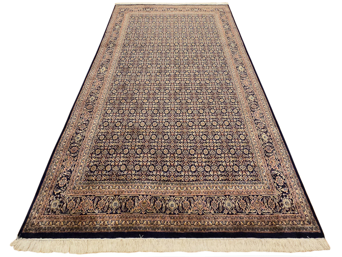 Rectangular Bidjar-style rug with navy field, geometric medallions, and fringe trim