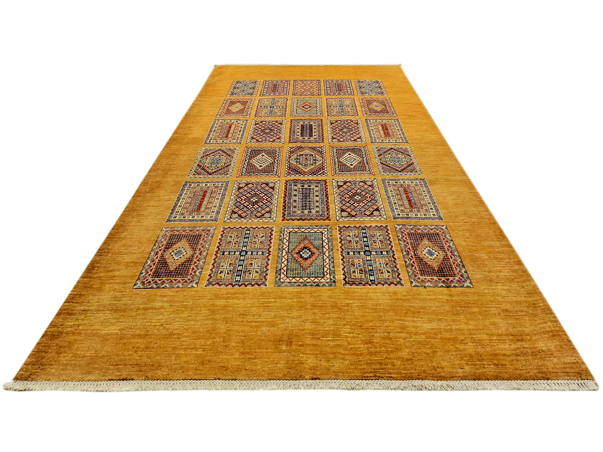 Long area rug with warm gold base and central grid of blue, red, and tan geometric motifs