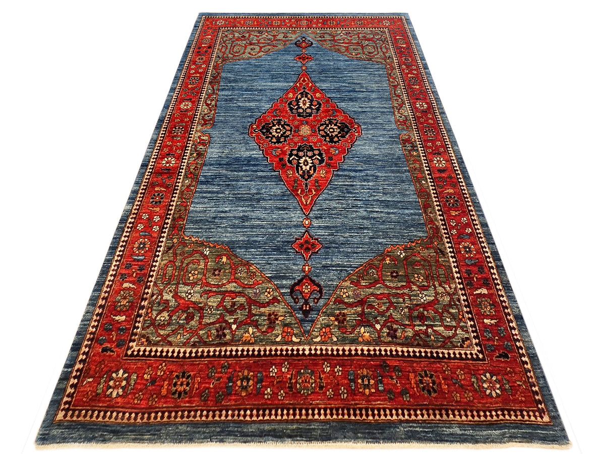 Oriental-style area rug with blue field, red medallion, and ornate border.