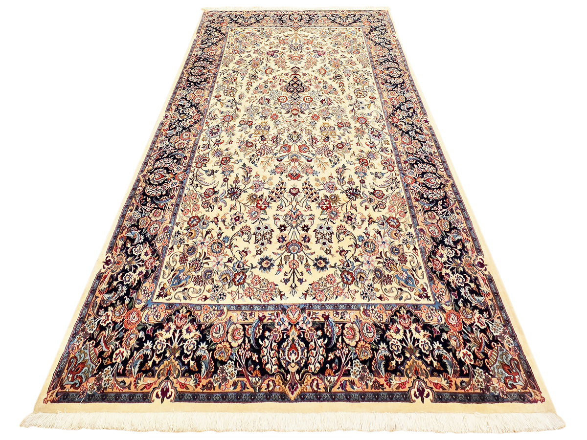 Rectangular rug with cream field, navy and rust ornate border, and cream fringe