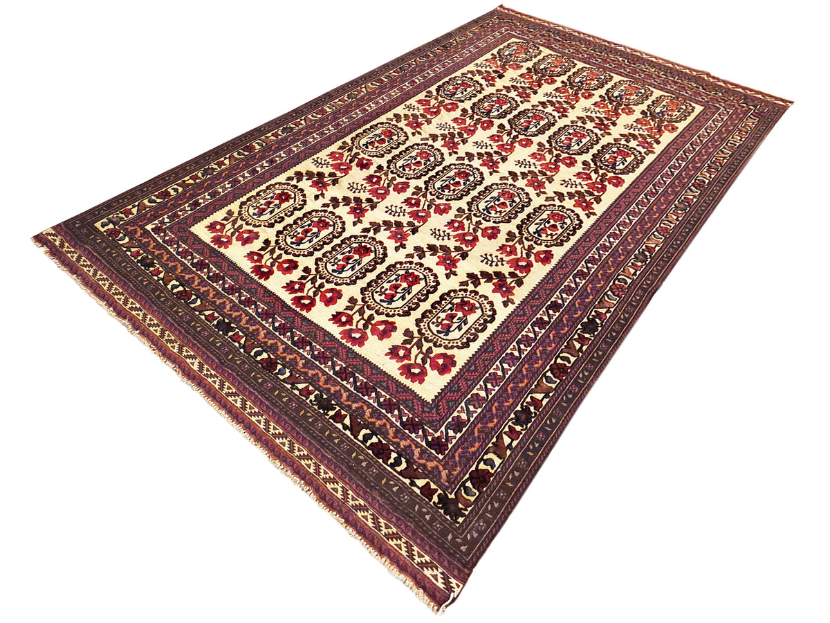 Corner view of rectangular area rug with cream background and burgundy, navy ornamental medallions.