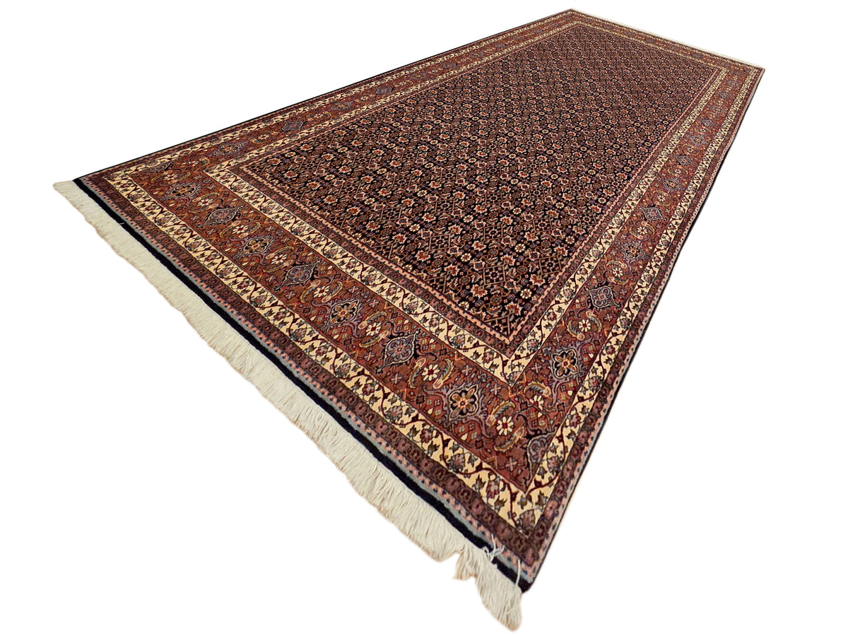 Diagonal view of rectangular rug with rust medallions and fringed edges
