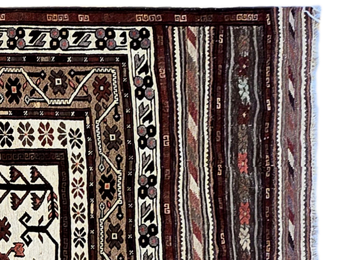 Soumak rug edge close-up with dense border motifs and vertical striped bands