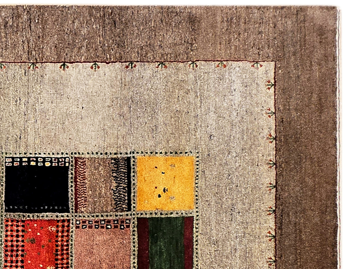 Loribaft rug close-up, beige textured edge with brown border and patchwork squares