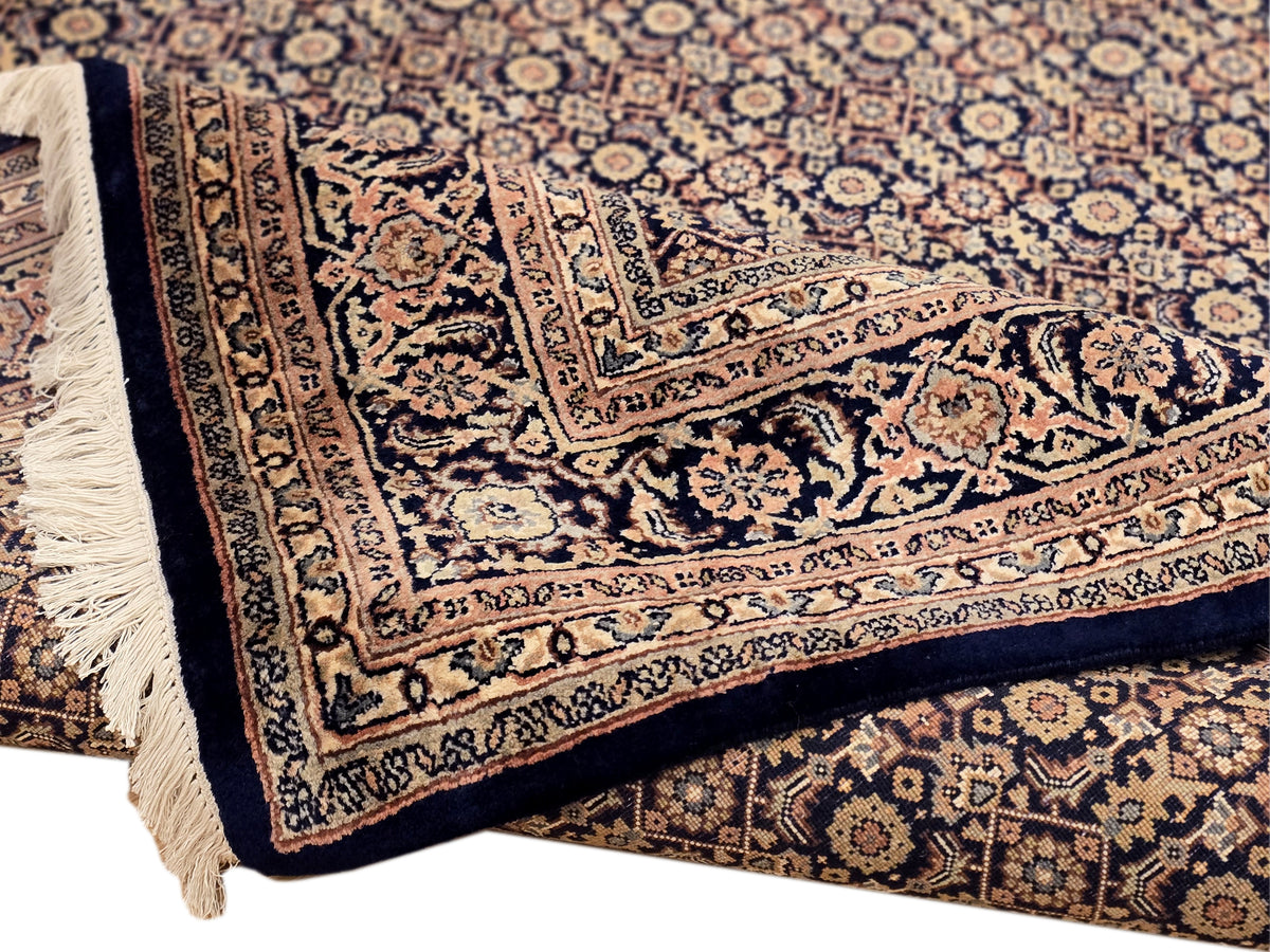 Bidjar-style rug corner detail with layered borders and cream fringe tassels