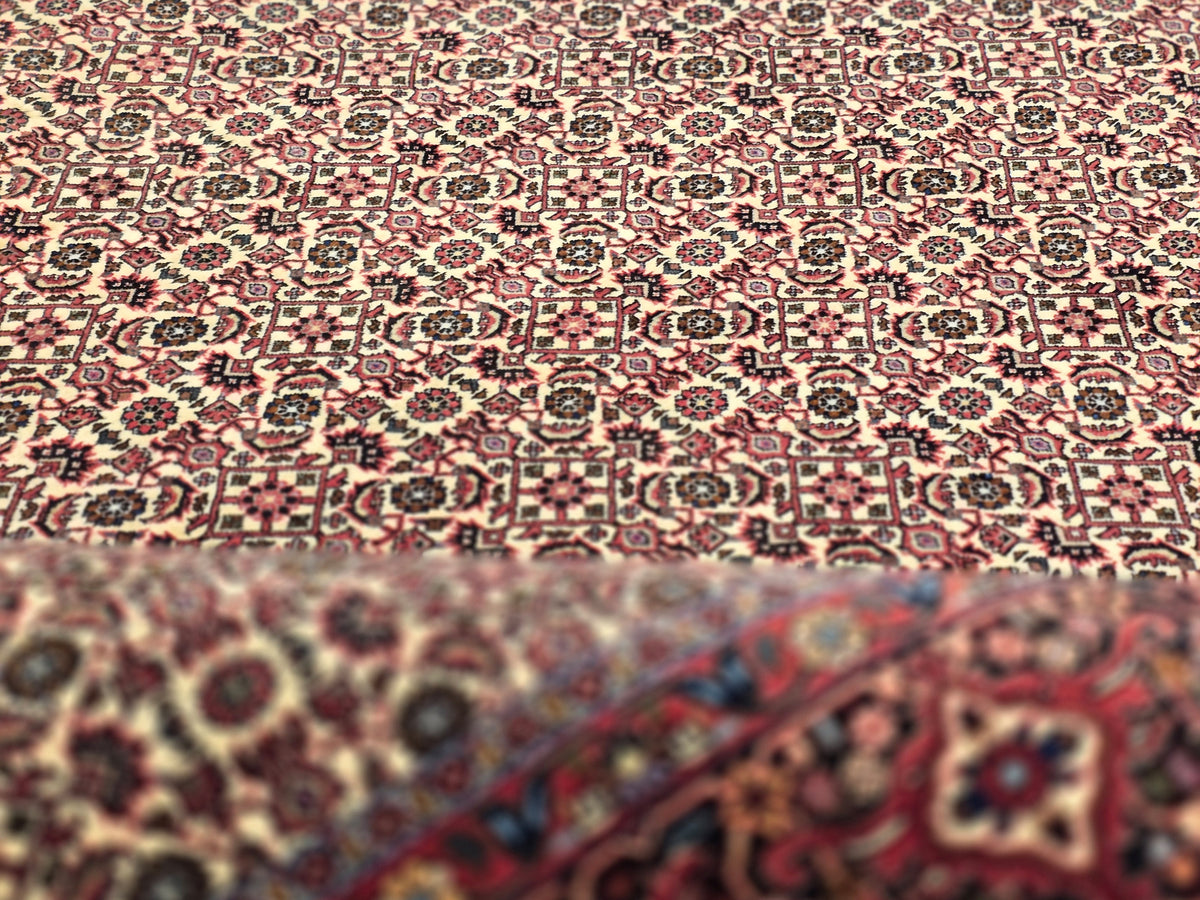Bidjar rug with red, cream, and navy geometric pattern, dense medallions and border