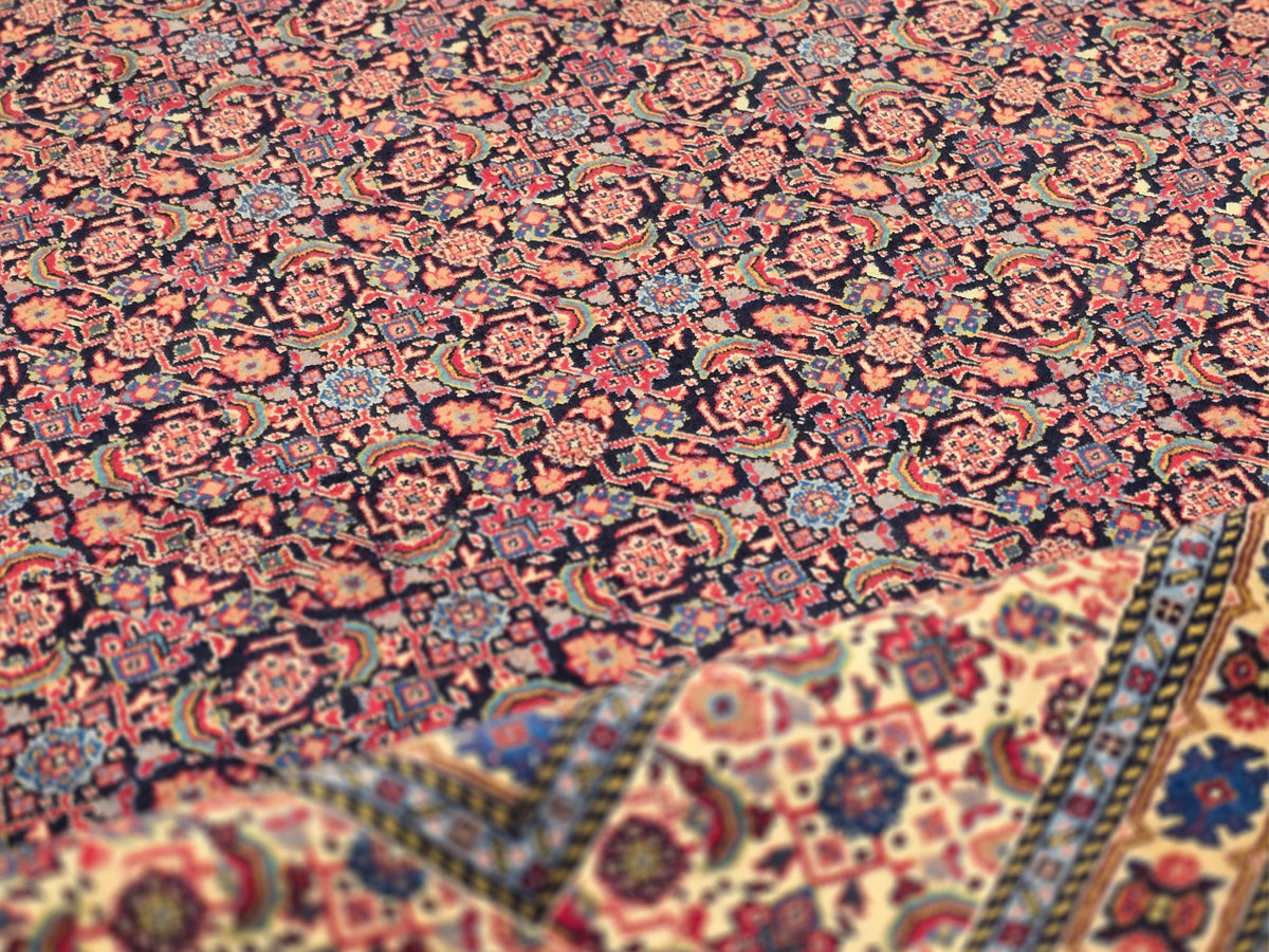 Multicolor Persian-style area rug with red, navy, and gold geometric motifs.