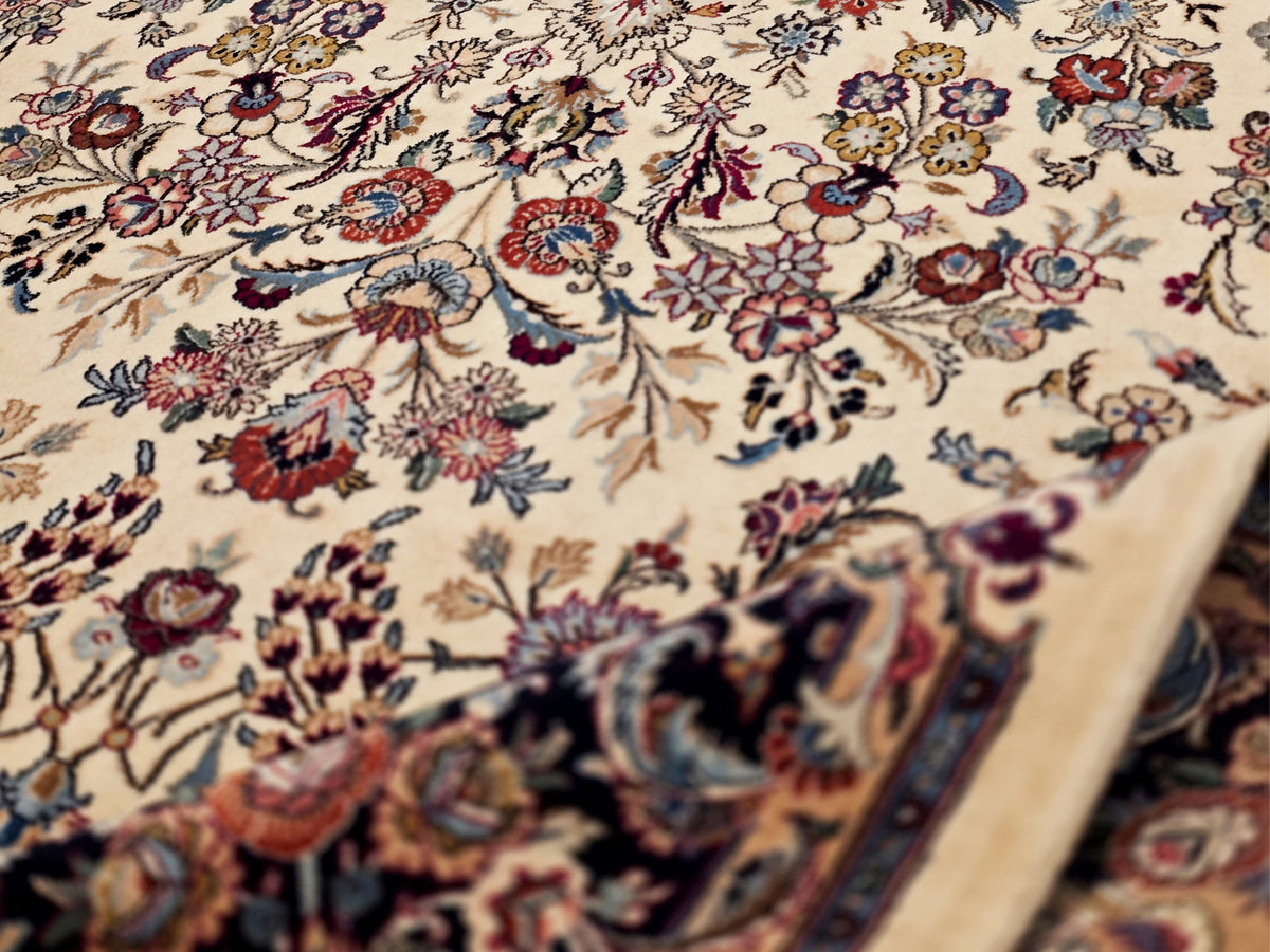 Floral Persian-style rug close-up: cream background with multicolor blossoms and vines