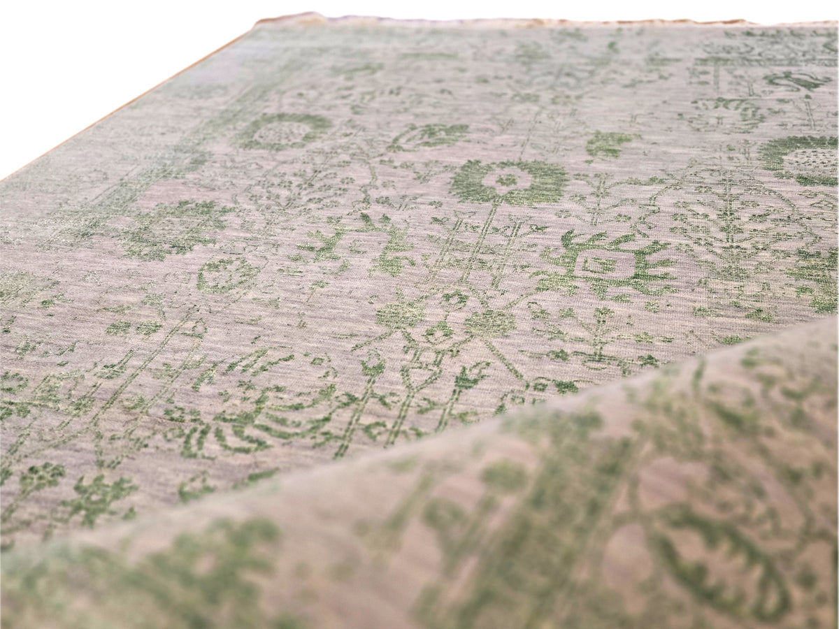 Light gray rug with green pattern, flat weave texture in close view