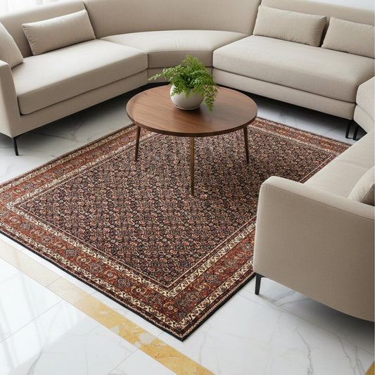 Rectangular geometric rug in dark red and rust tones placed on living room floor
