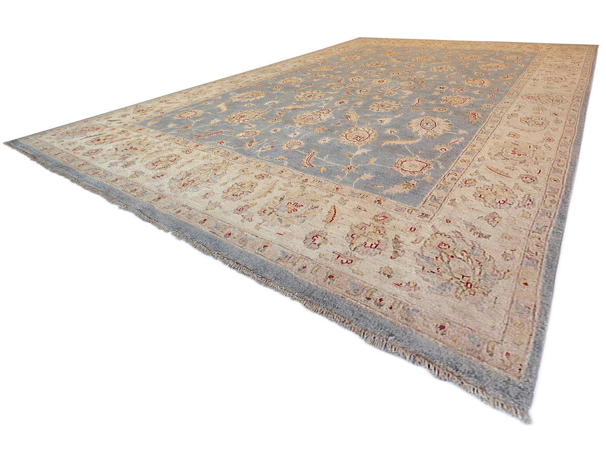 Large area rug with light blue floral motifs and beige border, short fringes