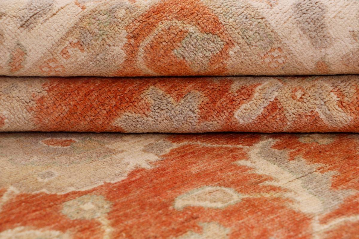 Terracotta and cream rug with abstract pattern and textured woven pile.