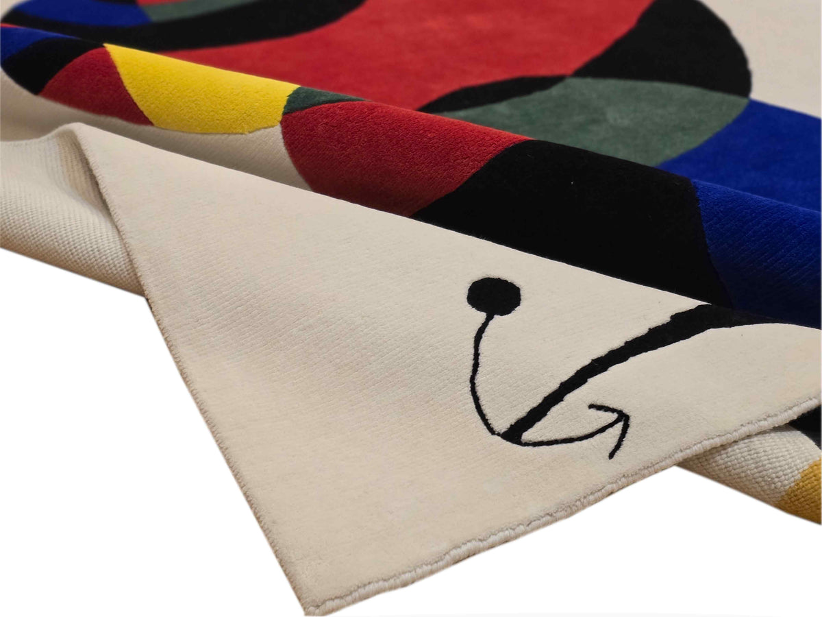 Abstract rug corner detail with off-white border and multicolor cat motif