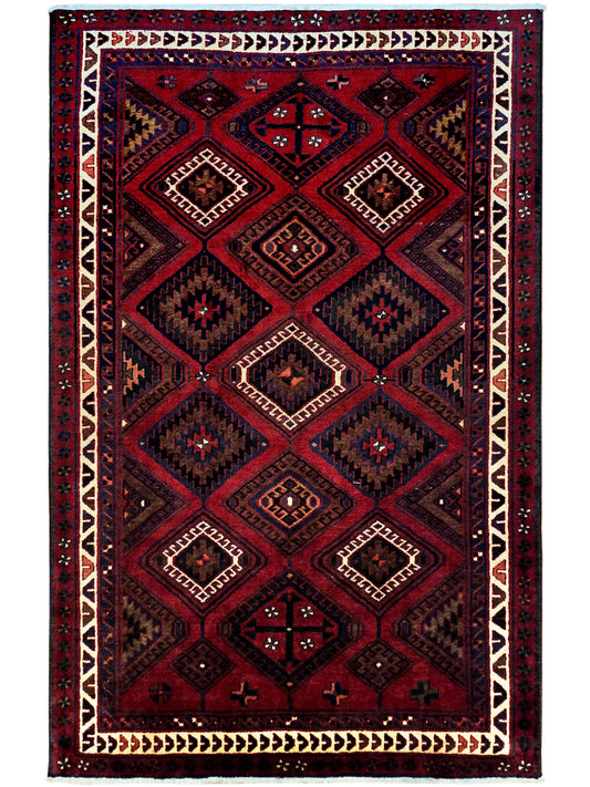 Rectangular red and navy geometric rug with cream diamond motifs and border