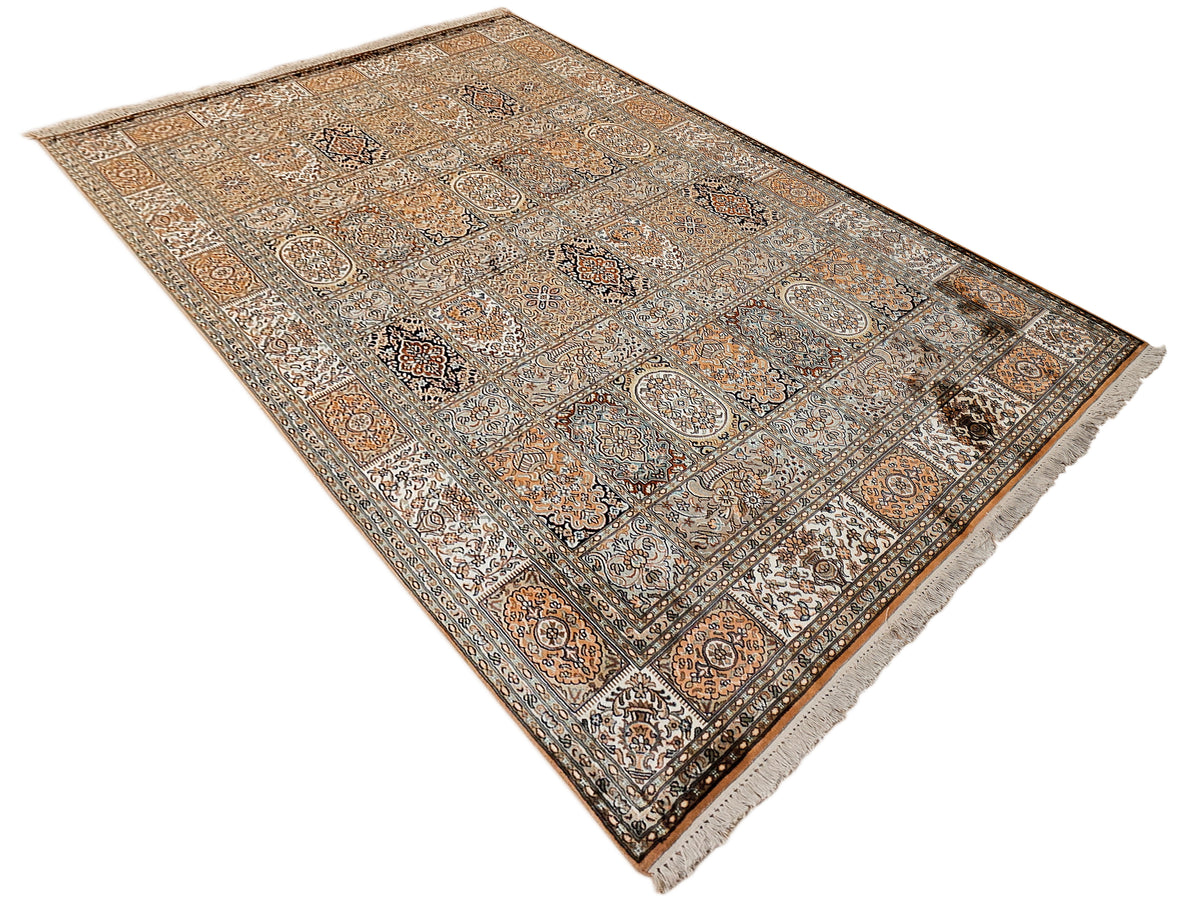Silk rug in diagonal view, detailed medallions and small motifs in earthy tones.