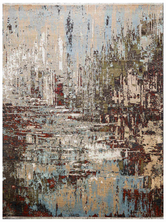 Rectangular abstract area rug with beige, blue and rust layered paint-like blocks.