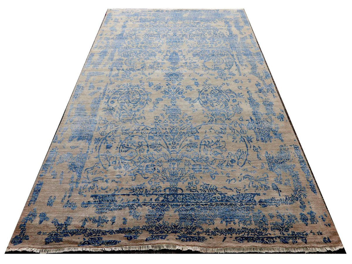 Rectangular modern rug with sky-blue abstract motifs and dark blue border, flat lay.