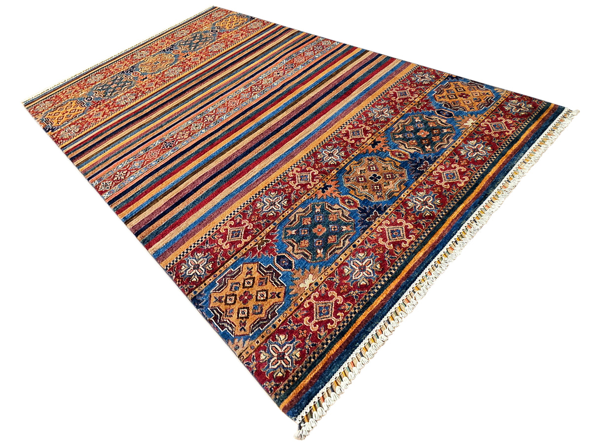 Rectangular rug with diagonal stripes, central medallion, and fringed border in multicolor