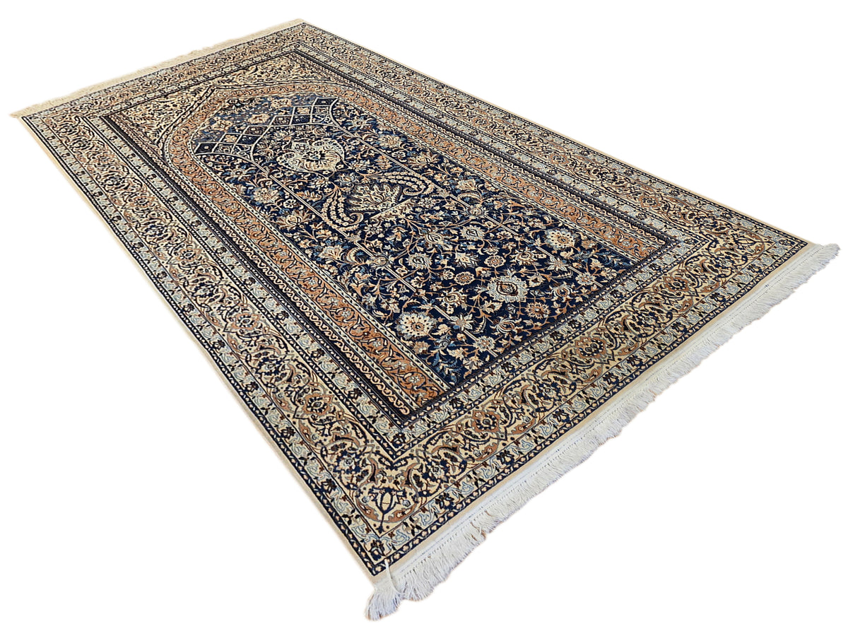 Navy blue and cream ornate Persian-style area rug with short fringe
