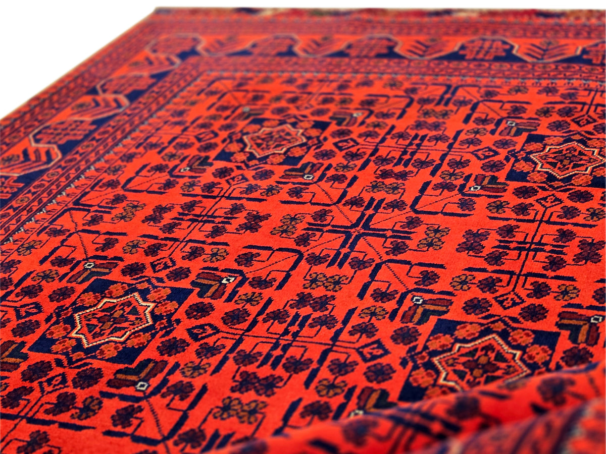Red rug surface with dense navy geometric motifs
