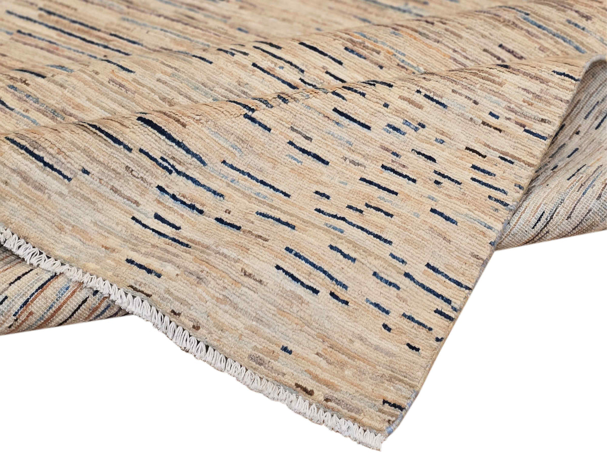 Close-up of Streepje Ziegler rug pile showing blue-gray stripe texture and fringed hem