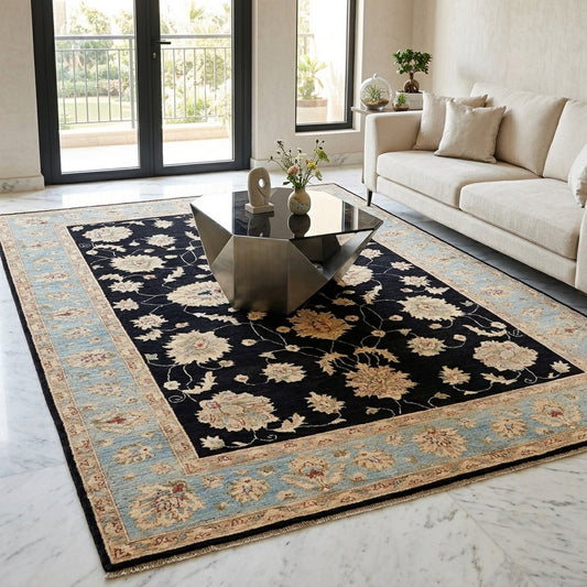 Black floral rug with light blue border, cream blossoms and vine lines