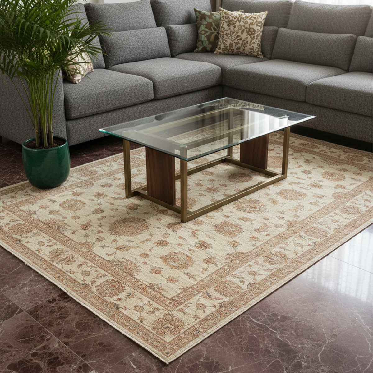 Cream rug with rust floral motifs and detailed border, laid on a living room floor.