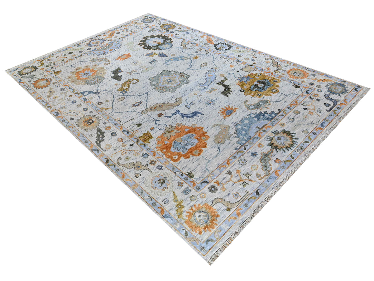 Oushak-style rug with light blue field, multicolor floral and scroll pattern, diamond shape