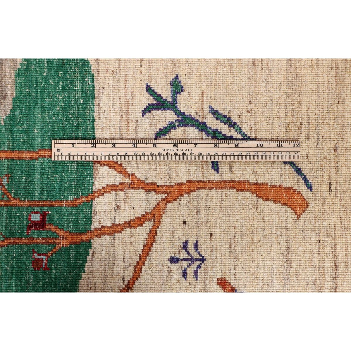 Ariana Gabbeh rug close-up with ruler detail, teal and orange tree motifs