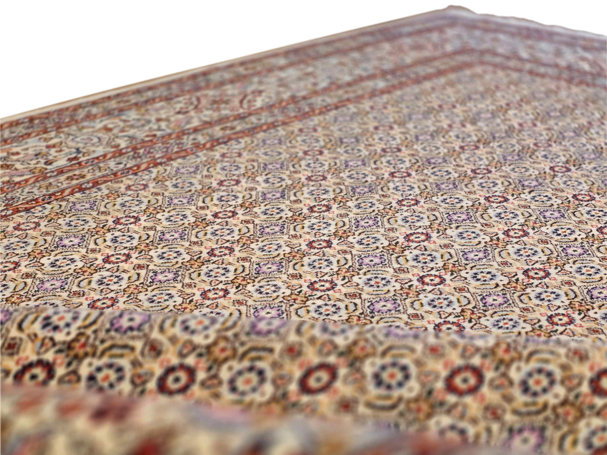 Persian rug close-up of patterned field with small medallions and multicolor accents
