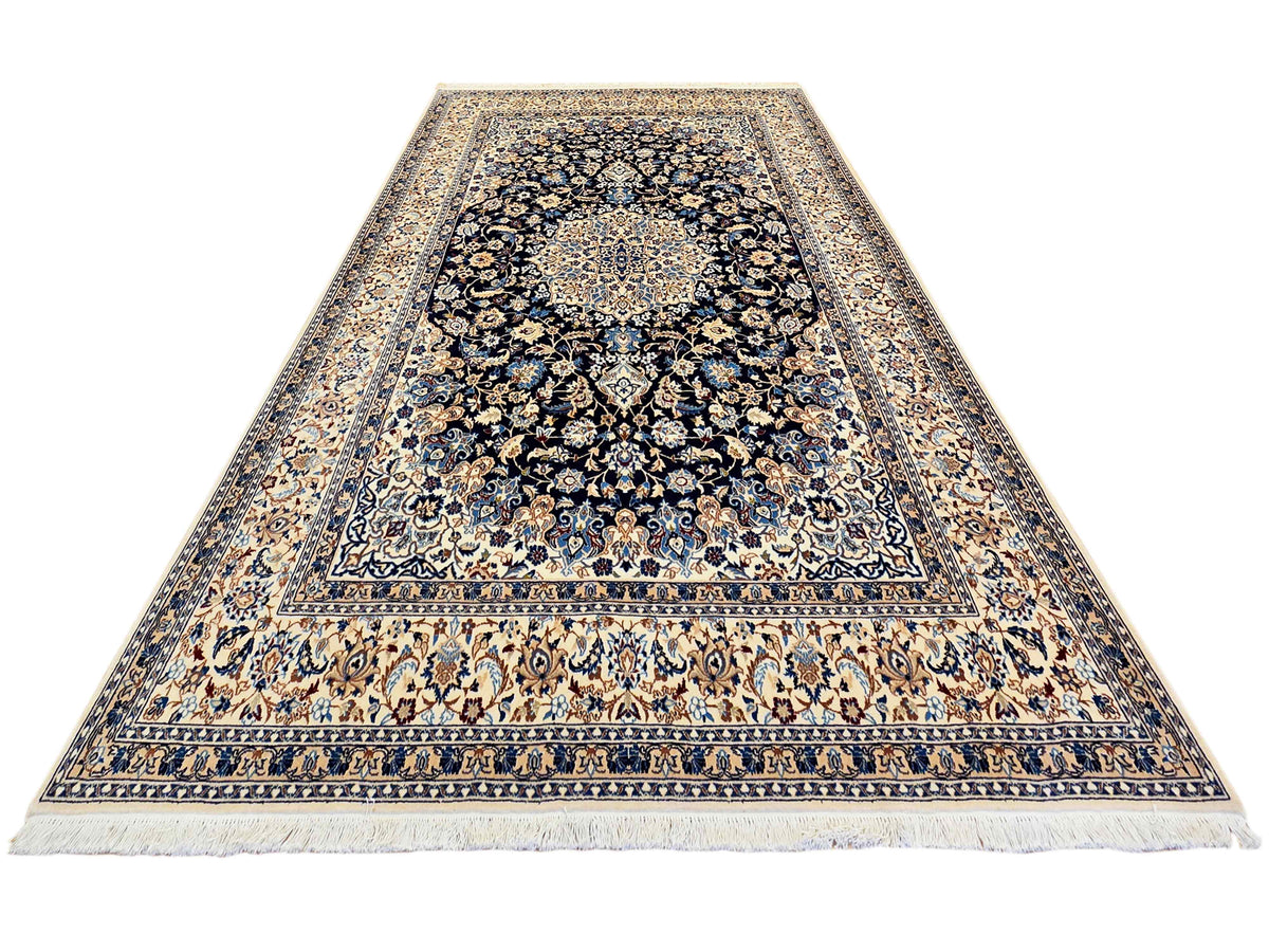 Nain rug area view with navy floral center and cream border, decorative medallions.