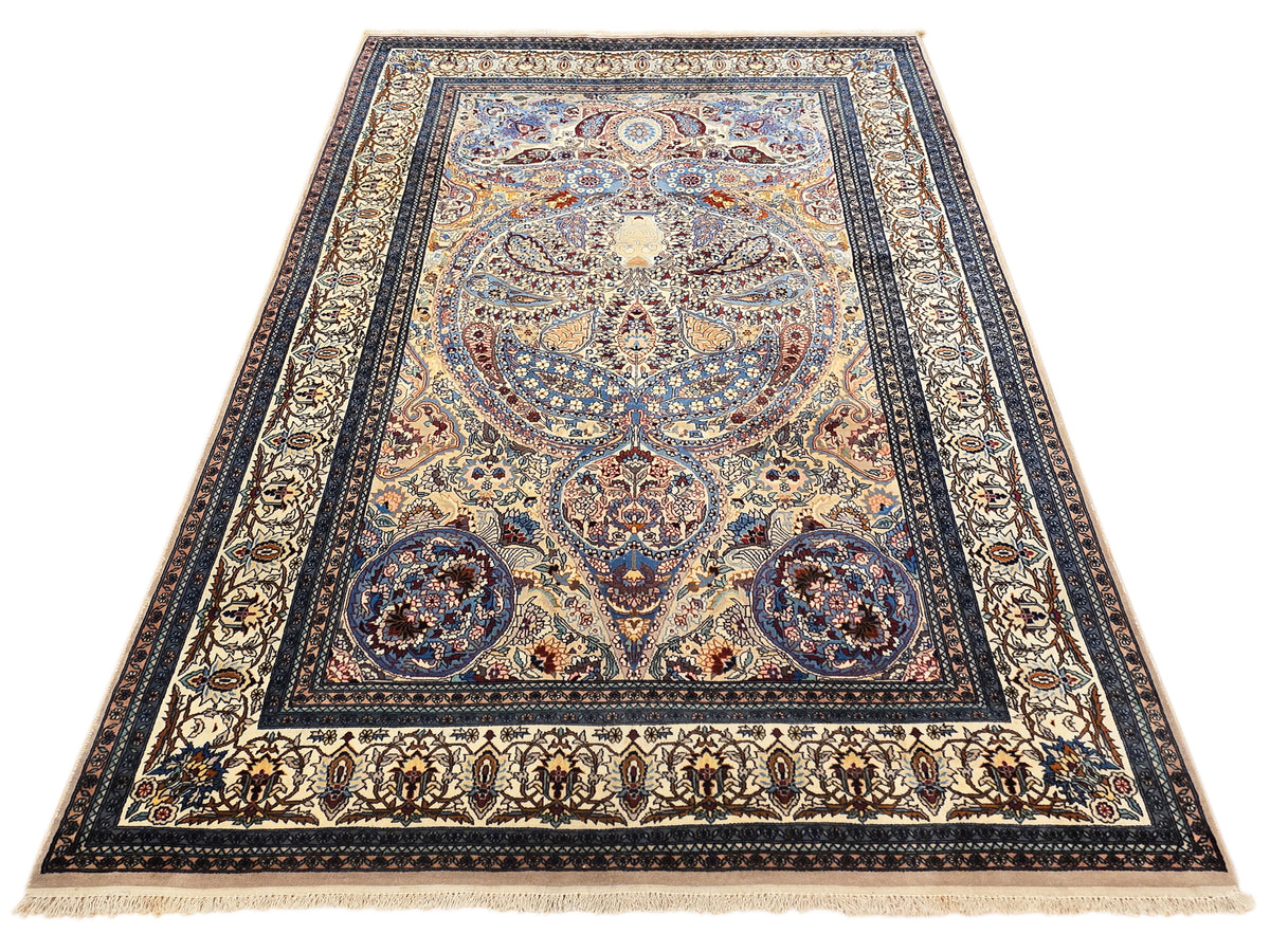 Rectangular blue Tabriz-style area rug with central medallion, decorative borders, and fringe.