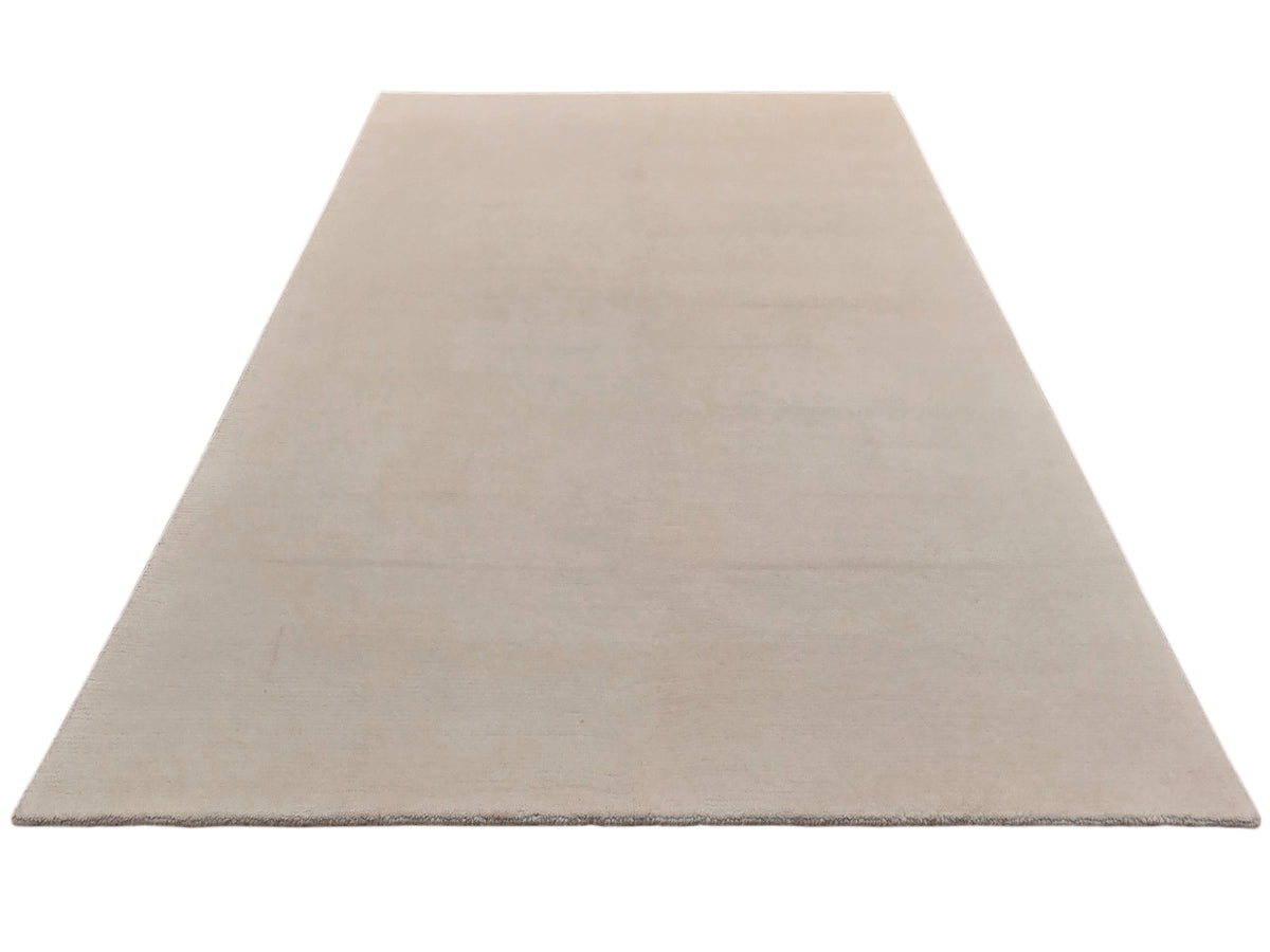 Light beige flatweave rug shown from an angled view with smooth, even finish.