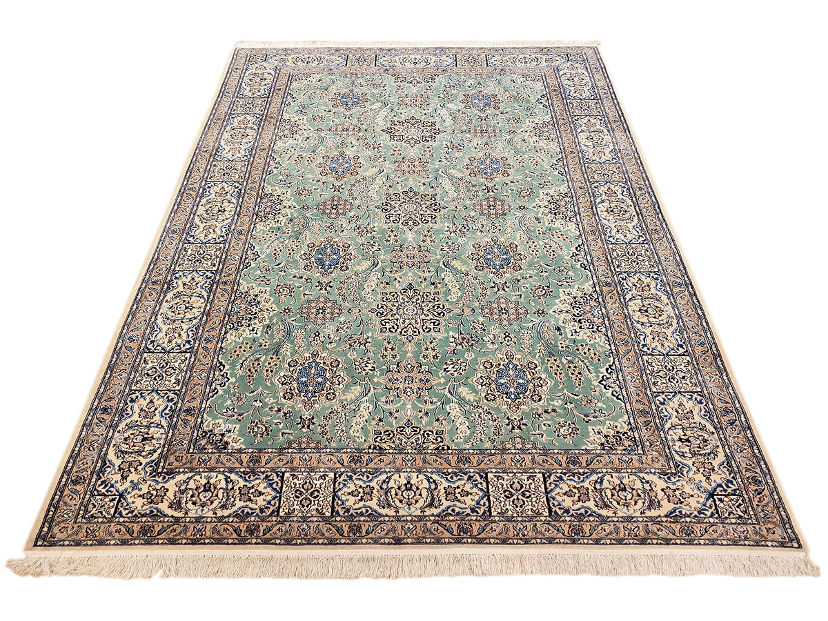 Nain rug with teal floral medallion, navy border, and light fringe edges