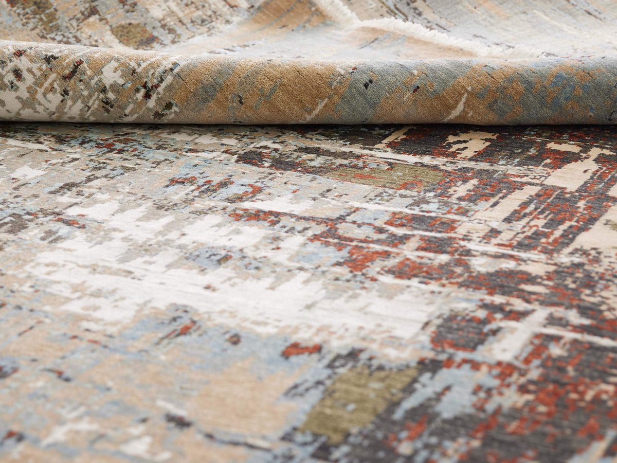 Rug surface detail with distressed beige, light blue and rust blocks; visible pile.