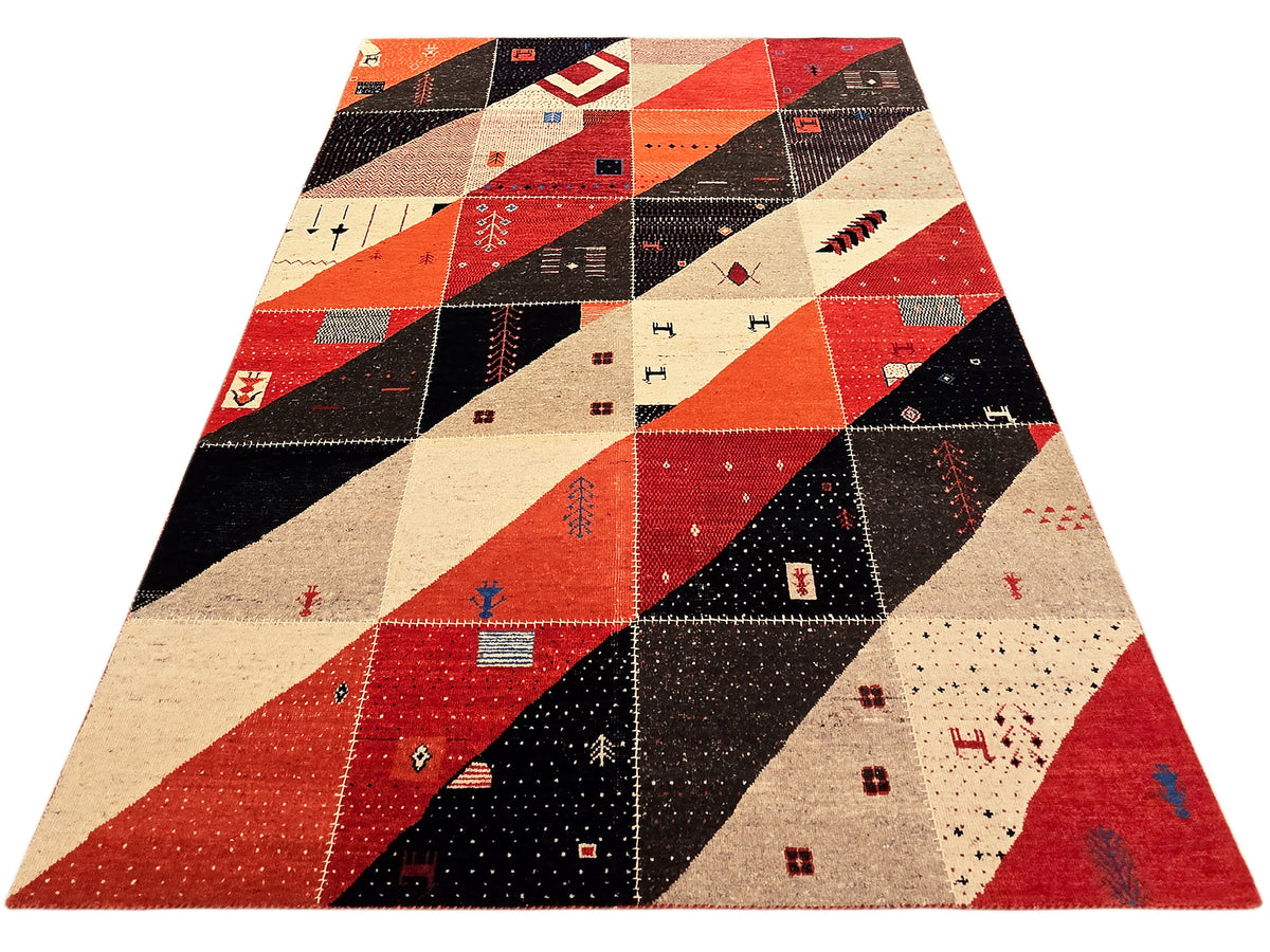 Patchwork Persian rug with red, cream, and black geometric design across the surface