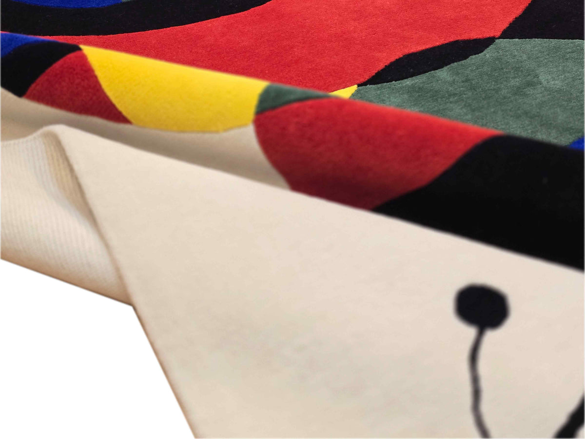 Abstract rug close-up with off-white pile and multicolor cat motif
